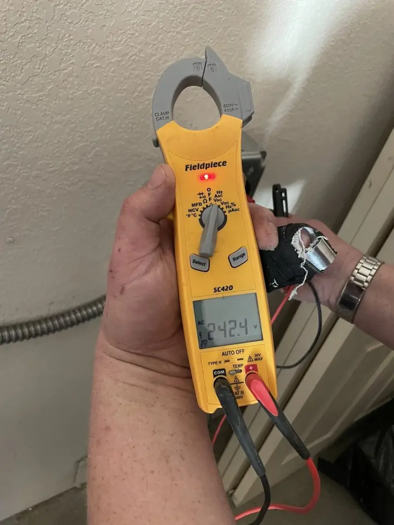 Voltage testing with clamp meter during Whole House Surge Protector in Livingston